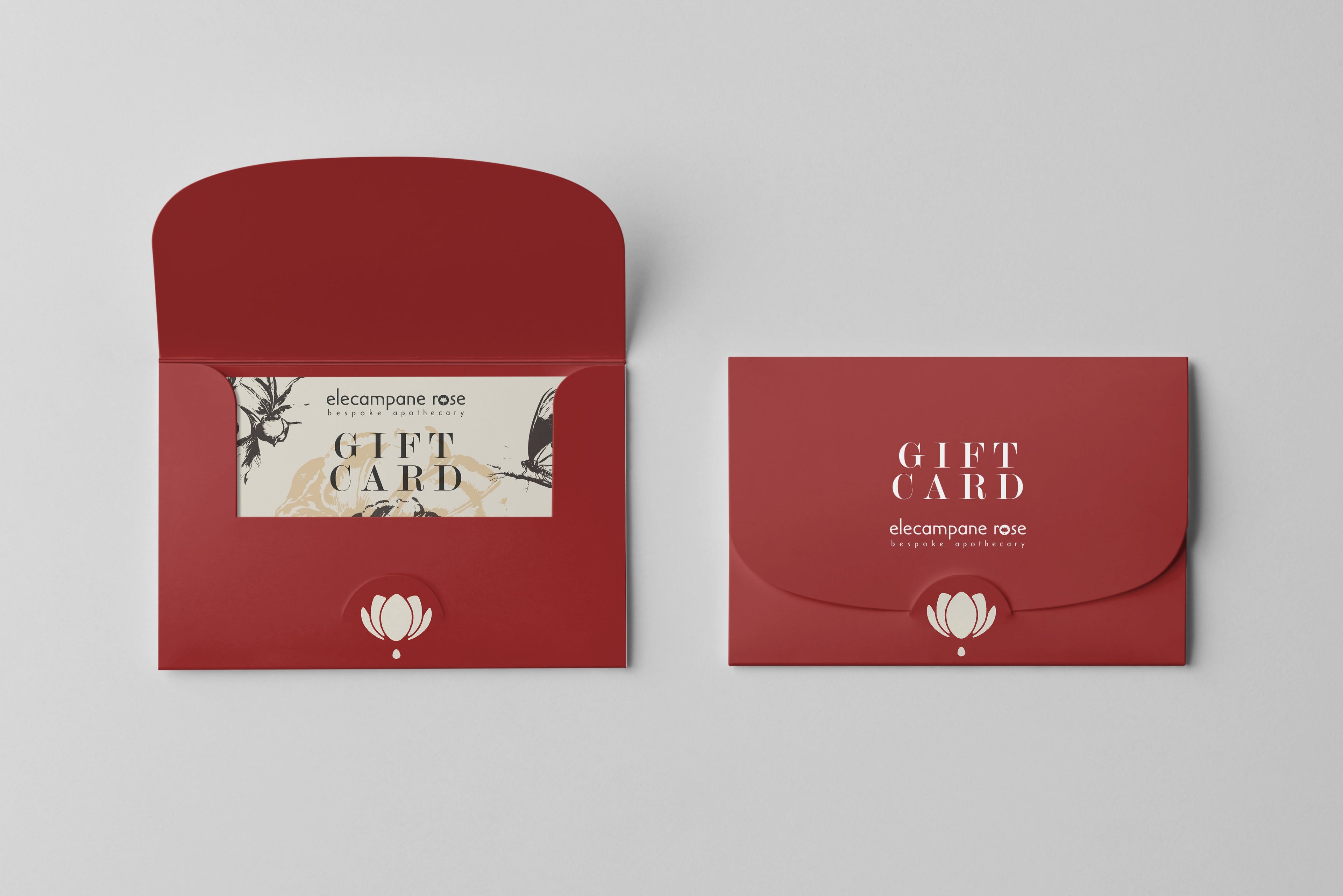 Elecampane Rose gift card in red holder open, and one closed next to it.