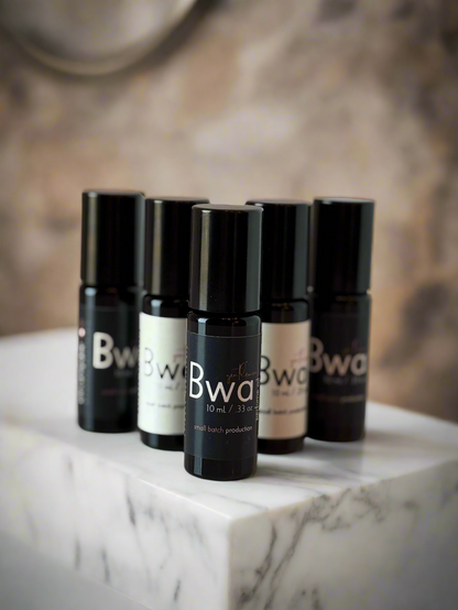Set of Bwa product bottles on a reflective surface with a blurred background