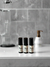 Three black and white bottles labeled &