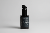 Black serum bottle with label on a light background